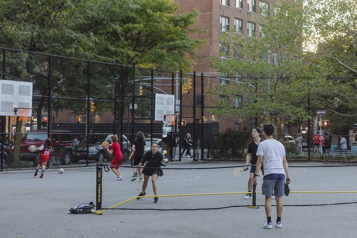 Pickleballers play at Corporal John A. Seravalli Playground in the West Village, next children playing basketball.